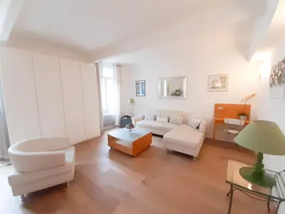 a living room with a white couch and a table at Gloria in Cannes