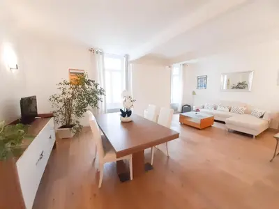 a living room with a table and a couch at Gloria in Cannes