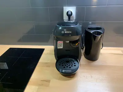 a black coffee maker sitting on a wooden counter at Cannes city center cozy studio 100 m from beach AC Wifi all within walking distance in Cannes