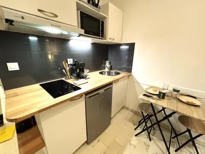 a kitchen with a sink and a counter top at Cannes city center cozy studio 100 m from beach AC Wifi all within walking distance in Cannes