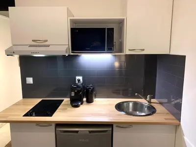 a kitchen counter with a sink and a microwave at Cannes city center cozy studio 100 m from beach AC Wifi all within walking distance in Cannes