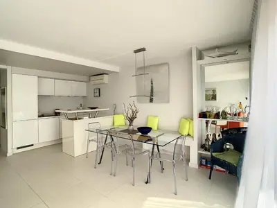 a kitchen and dining room with a table and chairs at Appartements centre ville Cannes in Cannes
