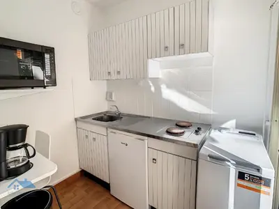 a small kitchen with a sink and a microwave at Appartements centre ville Cannes in Cannes