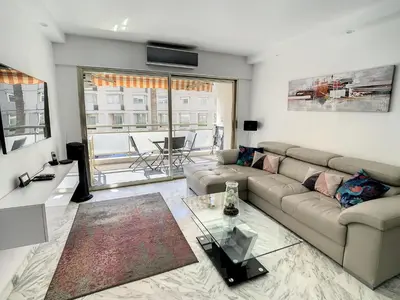 a living room with a couch and a table at Appartements centre ville Cannes in Cannes