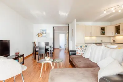 a living room with a couch and a table at Bright 2 Bed Apt in Cannes, 10 min to Palais in Cannes