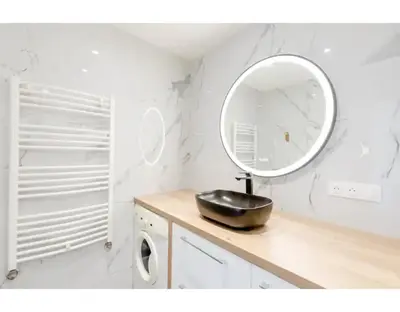 a mirror sitting on top of a counter in a bathroom at Bright 2 Bed Apt in Cannes, 10 min to Palais in Cannes