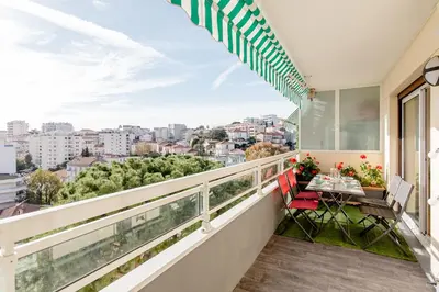 a balcony with a table and chairs and a view at Bright 2 Bed Apt in Cannes, 10 min to Palais in Cannes