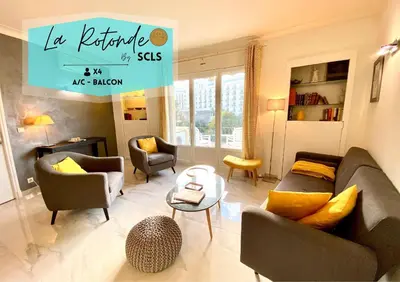 a living room with a couch and chairs and a table at La Rotonde By SCLS Locations in Cannes