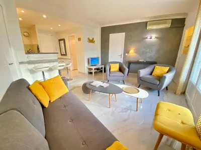 a living room with a couch and chairs and a table at La Rotonde By SCLS Locations in Cannes