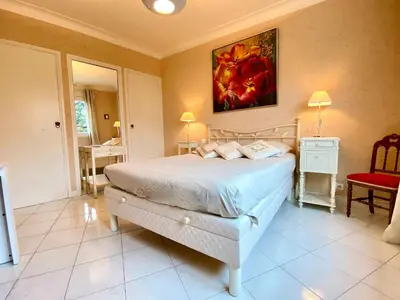 a bedroom with a bed and a painting on the wall at La Rotonde By SCLS Locations in Cannes