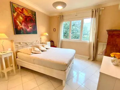 a bedroom with a bed and a large window at La Rotonde By SCLS Locations in Cannes