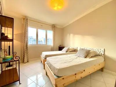 a bedroom with two beds and a window at La Rotonde By SCLS Locations in Cannes