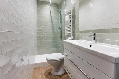 a white bathroom with a toilet and a sink at 