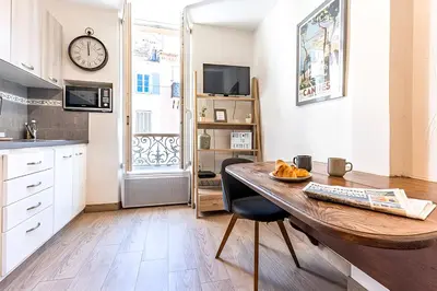 a kitchen with a wooden table and a clock on the wall at 