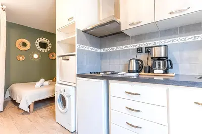 a kitchen with a washer and dryer in a room at 