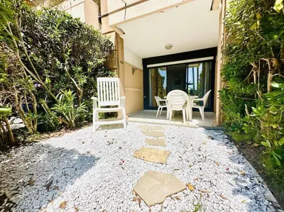 a pair of chairs sitting on the porch of a house at Front de mer, 8min du Palais des Festivals in Cannes