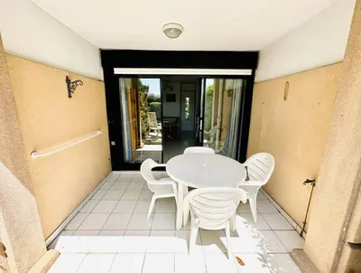 a white table and white chairs on a patio at Front de mer, 8min du Palais des Festivals in Cannes