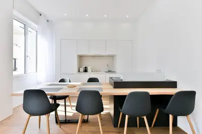 a dining room with a table and chairs at 3 DAUMAS - Superbe appartement 2 chambres hyper centre Cannes in Cannes