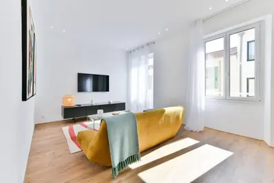 a living room with a couch and a tv at 3 DAUMAS - Superbe appartement 2 chambres hyper centre Cannes in Cannes
