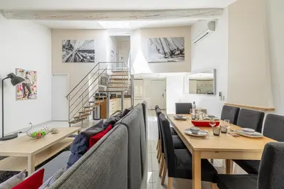a dining room with a table and chairs at MEY T3 - Magnifique LOFT 3 pièces à 50m du vieux port et des plages in Cannes
