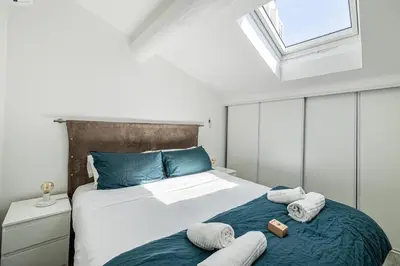 a bedroom with a bed with towels on it at MEY T3 - Magnifique LOFT 3 pièces à 50m du vieux port et des plages in Cannes