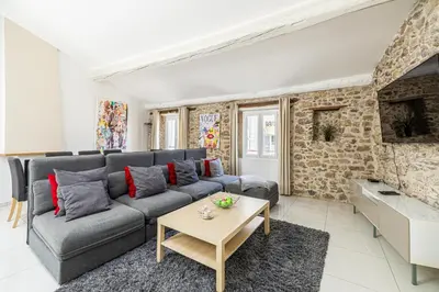 a living room with a couch and a table at MEY T3 - Magnifique LOFT 3 pièces à 50m du vieux port et des plages in Cannes
