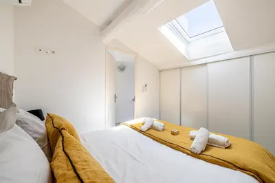 a bedroom with a bed with towels on it at MEY T3 - Magnifique LOFT 3 pièces à 50m du vieux port et des plages in Cannes