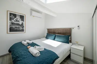 a bedroom with a bed with towels on it at MEY T3 - Magnifique LOFT 3 pièces à 50m du vieux port et des plages in Cannes