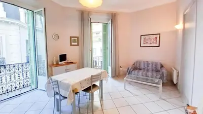 a dining room with a table and a chair at Mimosa 1 in Cannes