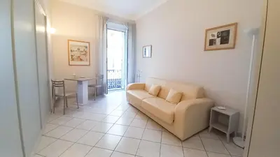 a living room with a couch and a table at Mimosa 1 in Cannes