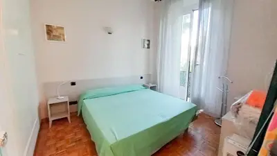 a green bed in a white room with a window at Mimosa 1 in Cannes