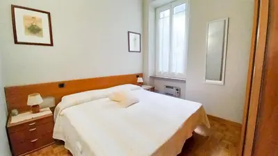 a bedroom with a white bed and a window at Mimosa 2 in Cannes