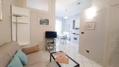 a living room with a couch and a table at Mimosa 2 in Cannes