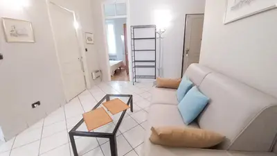 a living room with a couch and a table at Mimosa 2 in Cannes