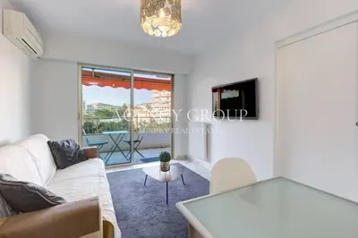 a living room with a couch and a table at Appartement, 2 pièces, à deux pas de la Croisette in Cannes