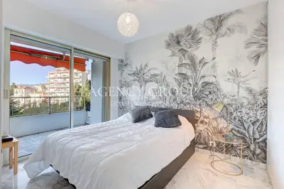 a bedroom with a bed and a large window at Appartement, 2 pièces, à deux pas de la Croisette in Cannes