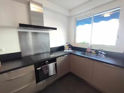 a kitchen with a sink and a stove top oven at Cannes Pointe Croisette T2 plage 2min à pieds 46m2 in Cannes