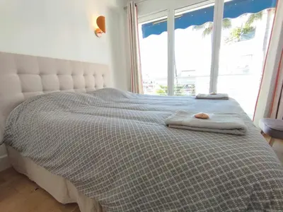 a bed with two towels on it in front of a window at Cannes Pointe Croisette T2 plage 2min à pieds 46m2 in Cannes