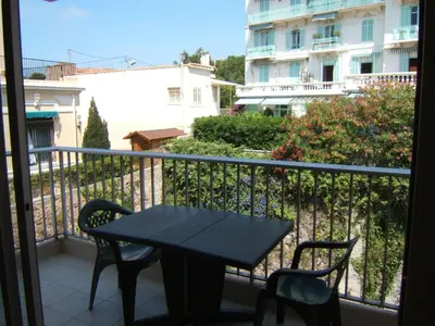 a black table and chairs on a balcony at Eden Residence in Cannes