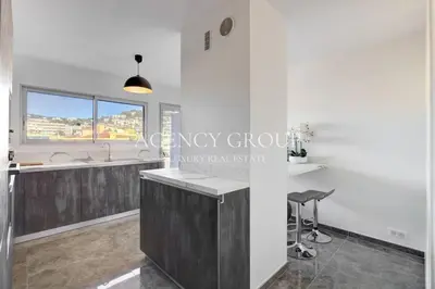 a kitchen with white walls and a counter top at Appartement 3P - Vue Mer - Proche de la Croisette in Cannes