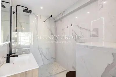 a white bathroom with a shower and a sink at Appartement 3P - Vue Mer - Proche de la Croisette in Cannes