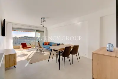 a kitchen and living room with a table and chairs at Appartement 3P - Vue Mer - Proche de la Croisette in Cannes