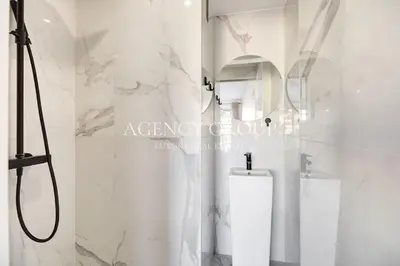a white bathroom with a shower and a toilet at Appartement 3P - Vue Mer - Proche de la Croisette in Cannes