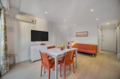 a living room with a table and chairs and a couch at Confortable Studio BALCON, Rouaze- CARLON MARTINEZ A0B123 in Cannes
