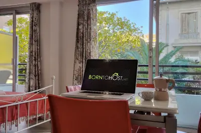 a laptop sitting on a table in front of a window at Confortable Studio BALCON, Rouaze- CARLON MARTINEZ A0B123 in Cannes