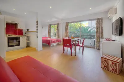 a living room with a couch and a table with chairs at Confortable Studio BALCON, Rouaze- CARLON MARTINEZ A0B123 in Cannes