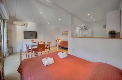 a bedroom with a bed and a dining room at Confortable Studio BALCON, Rouaze- CARLON MARTINEZ A0B123 in Cannes