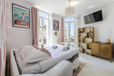 a bedroom with a bed and a couch in it at VIP - Lovely studio for 2 people 5 minutes from Palais des Festivals in Cannes