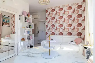a living room with a couch and a table at VIP - Lovely studio for 2 people 5 minutes from Palais des Festivals in Cannes