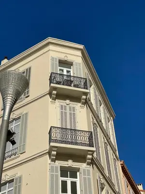 a tall white building with balconies and a street light at VIP - Lovely studio for 2 people 5 minutes from Palais des Festivals in Cannes